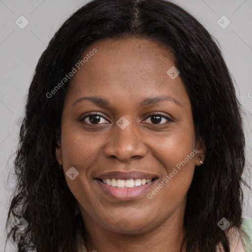 Joyful black young-adult female with long  brown hair and brown eyes