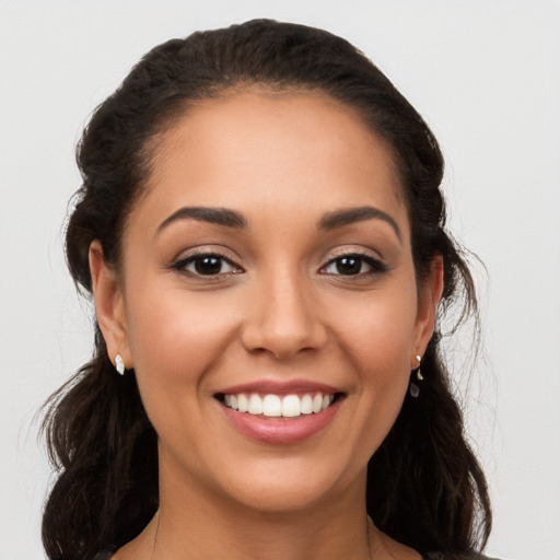 Joyful white young-adult female with long  black hair and brown eyes