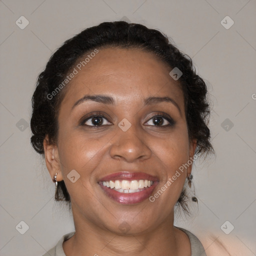 Joyful black adult female with medium  brown hair and brown eyes