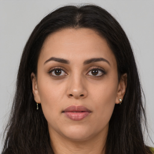 Neutral latino young-adult female with long  brown hair and brown eyes