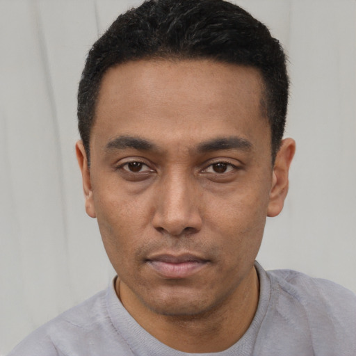 Neutral latino young-adult male with short  black hair and brown eyes