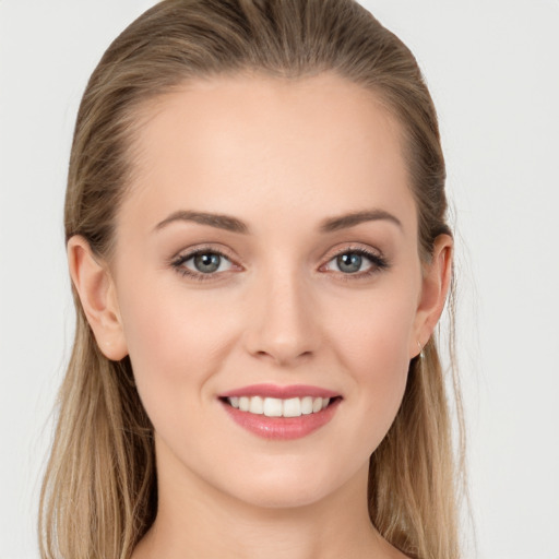 Joyful white young-adult female with long  brown hair and grey eyes