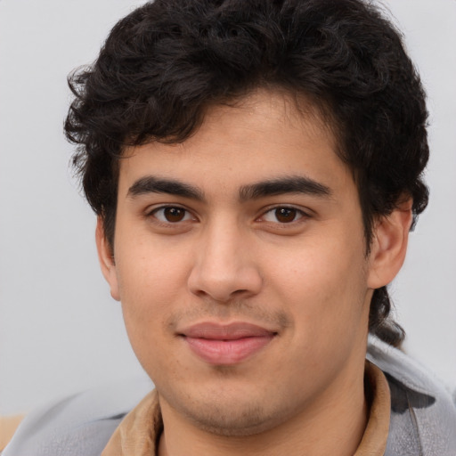 Joyful latino young-adult male with short  brown hair and brown eyes