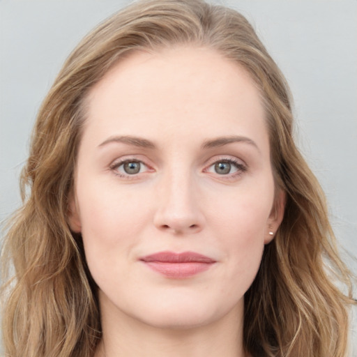 Joyful white young-adult female with long  brown hair and blue eyes