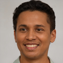 Joyful latino young-adult male with short  brown hair and brown eyes