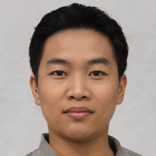 Joyful asian young-adult male with short  black hair and brown eyes