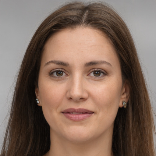 Joyful white adult female with long  brown hair and brown eyes