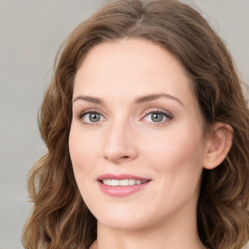 Joyful white young-adult female with medium  brown hair and green eyes