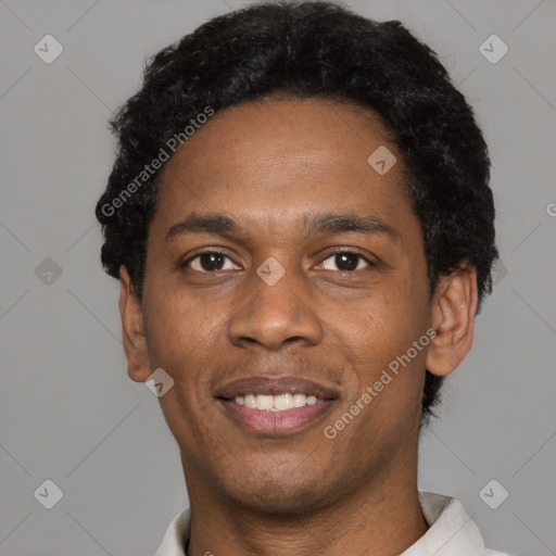 Joyful black young-adult male with short  black hair and brown eyes