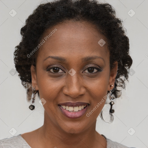 Joyful black adult female with short  brown hair and brown eyes