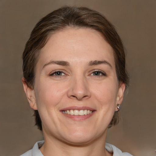 Joyful white adult female with medium  brown hair and brown eyes