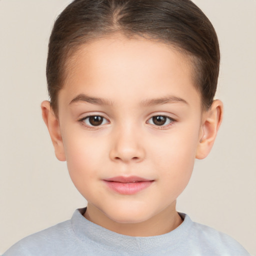 Joyful white child female with short  brown hair and brown eyes