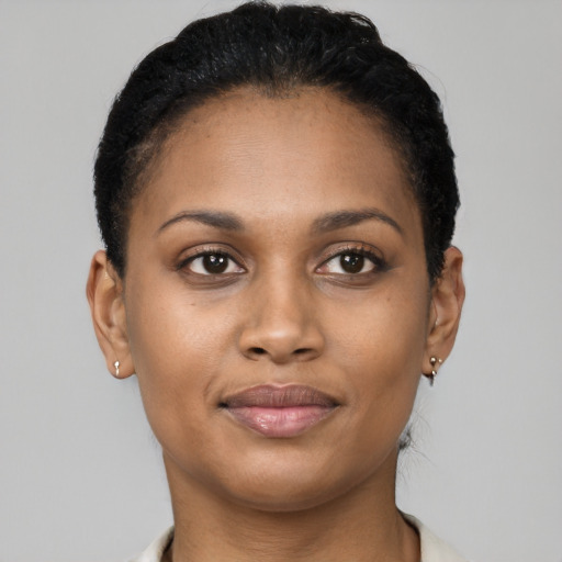 Joyful black young-adult female with short  brown hair and brown eyes