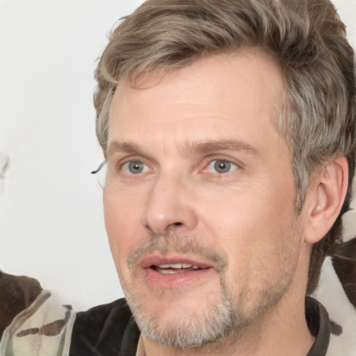 Joyful white adult male with short  brown hair and grey eyes