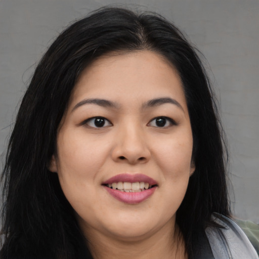 Joyful asian young-adult female with medium  black hair and brown eyes
