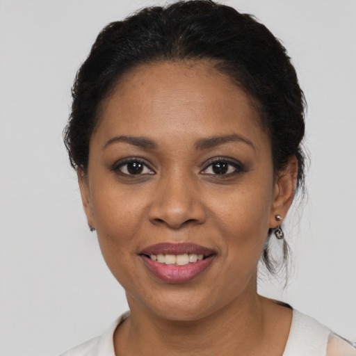 Joyful latino young-adult female with short  brown hair and brown eyes