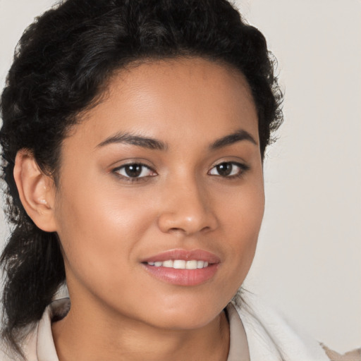 Joyful latino young-adult female with medium  brown hair and brown eyes