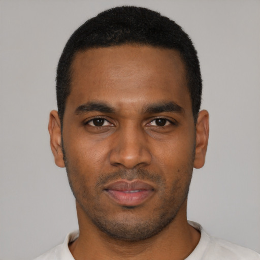 Joyful black young-adult male with short  black hair and brown eyes