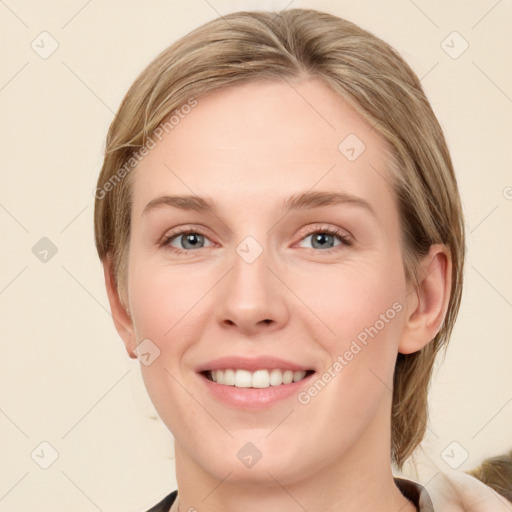 Joyful white young-adult female with medium  brown hair and blue eyes