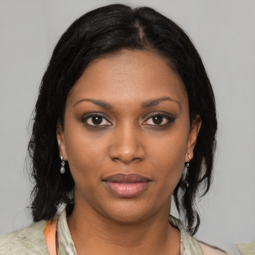 Joyful black young-adult female with medium  black hair and brown eyes