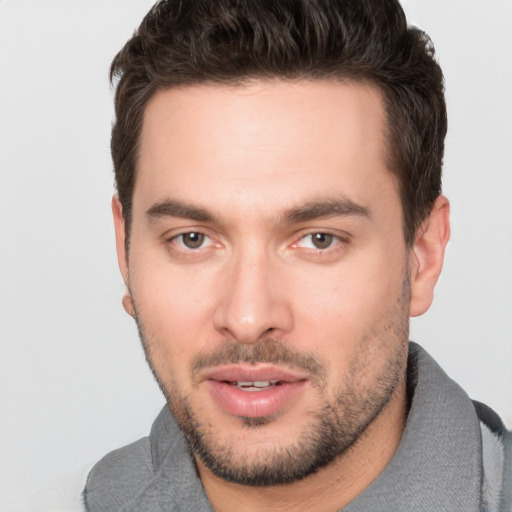 Joyful white young-adult male with short  brown hair and brown eyes