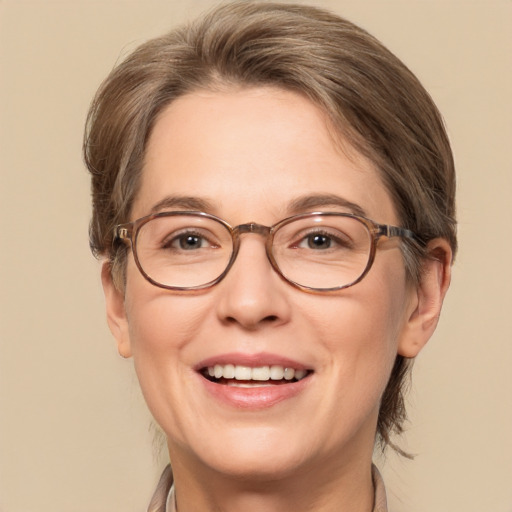 Joyful white adult female with medium  brown hair and green eyes