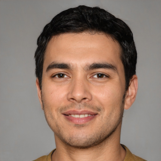 Joyful white young-adult male with short  black hair and brown eyes