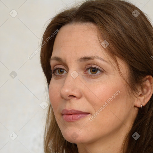 Joyful white adult female with long  brown hair and brown eyes