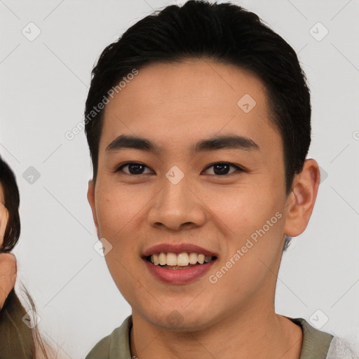 Joyful latino young-adult male with short  black hair and brown eyes