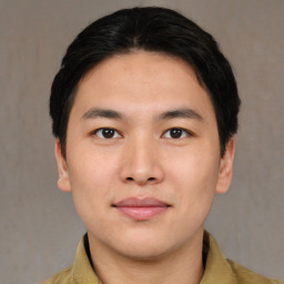 Joyful asian young-adult male with short  brown hair and brown eyes