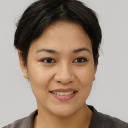 Joyful asian young-adult female with short  brown hair and brown eyes