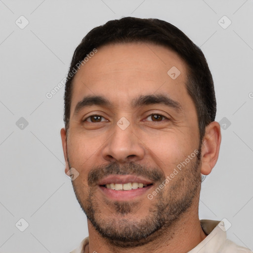 Joyful white young-adult male with short  black hair and brown eyes