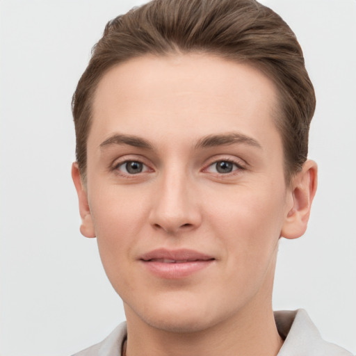 Joyful white young-adult female with short  brown hair and grey eyes