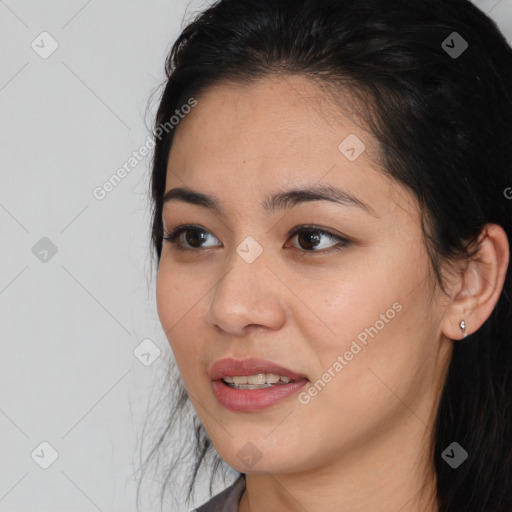 Joyful latino young-adult female with medium  brown hair and brown eyes