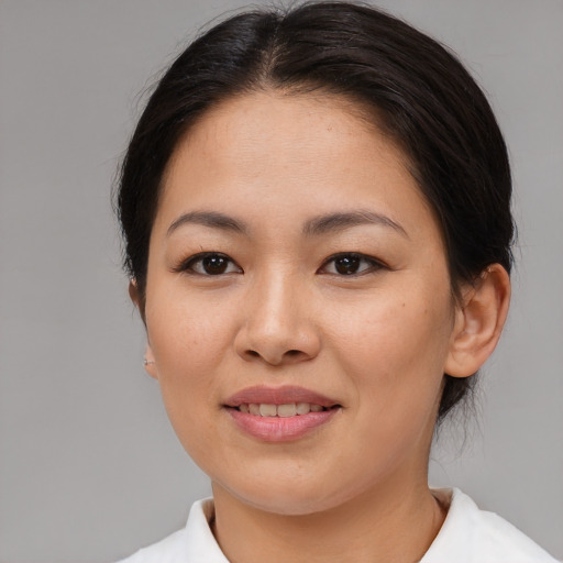 Joyful asian young-adult female with medium  brown hair and brown eyes