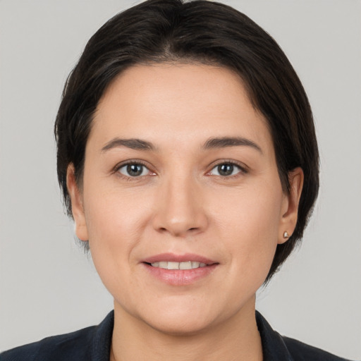 Joyful white young-adult female with medium  brown hair and brown eyes