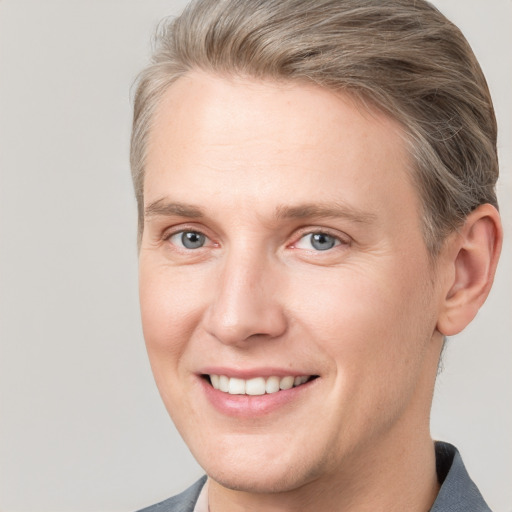 Joyful white adult male with short  brown hair and grey eyes