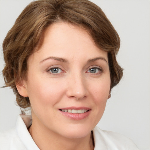 Joyful white young-adult female with medium  brown hair and grey eyes