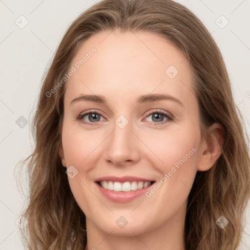 Joyful white young-adult female with long  brown hair and blue eyes