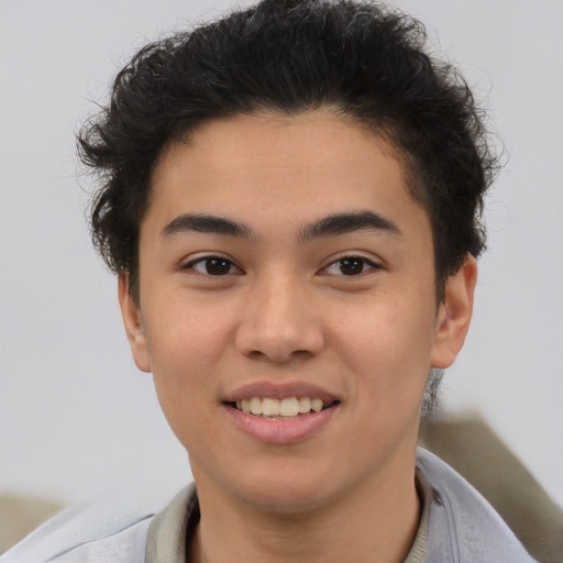 Joyful latino young-adult male with short  brown hair and brown eyes