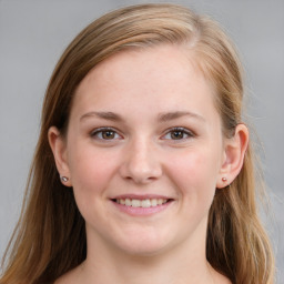 Joyful white young-adult female with medium  brown hair and blue eyes