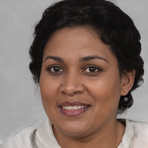 Joyful black adult female with short  brown hair and brown eyes