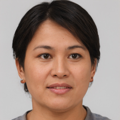 Joyful asian adult female with short  brown hair and brown eyes