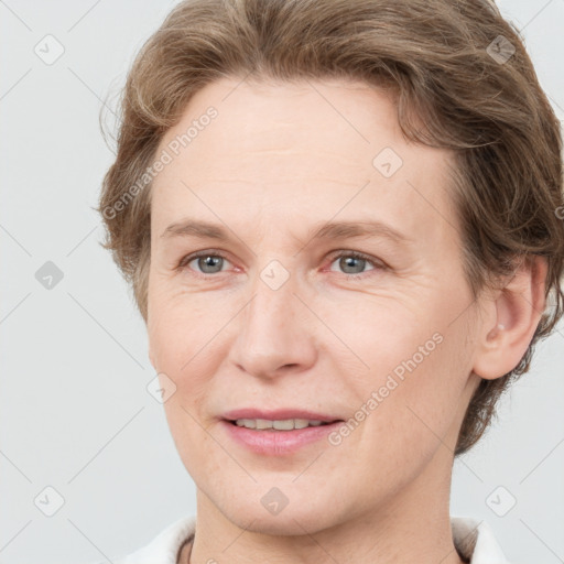 Joyful white adult female with short  brown hair and grey eyes