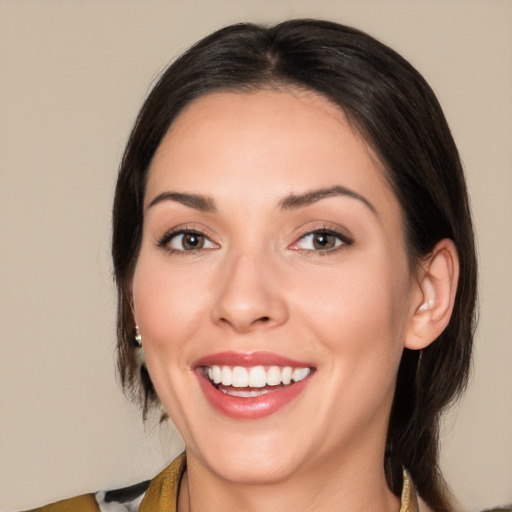 Joyful white young-adult female with medium  black hair and brown eyes