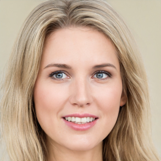 Joyful white young-adult female with long  brown hair and blue eyes