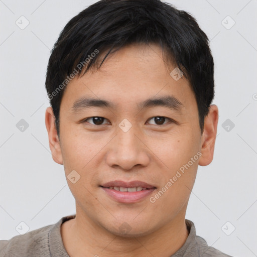 Joyful asian young-adult male with short  brown hair and brown eyes