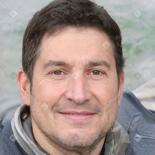 Joyful white adult male with short  brown hair and grey eyes