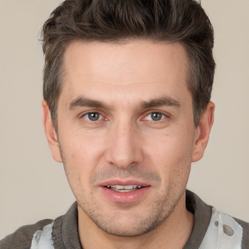 Joyful white adult male with short  brown hair and brown eyes