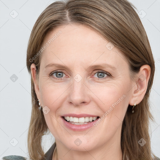 Joyful white adult female with medium  brown hair and blue eyes